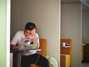 man wearing white top using MacBook