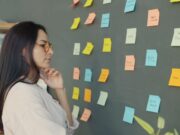 Woman looking at sticky notes on a wall