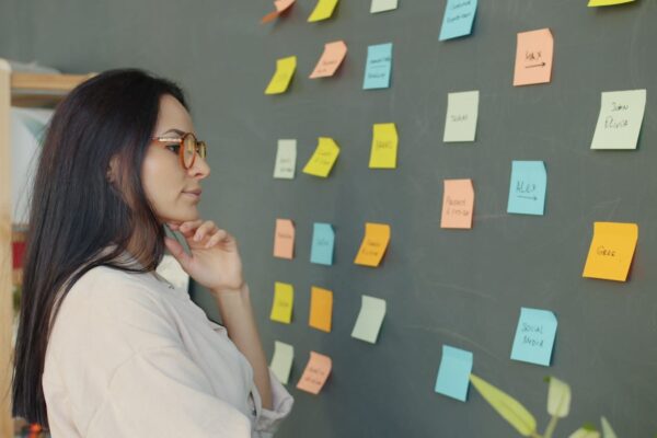 Woman looking at sticky notes on a wall
